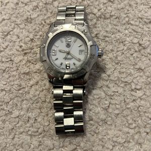 Used women's Tag Heur watch, needs new battery, stainless steel, has scratches